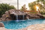 Large heated pool with water fall, water slide, and spa
